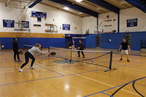 People playing Pickleball indoors